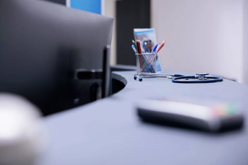 Doctor's desk with stethoscope – out-of-pocket medical costs for workplace injury