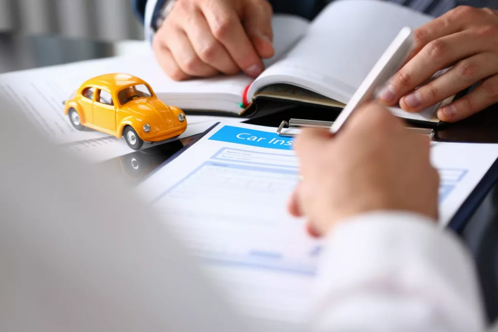 signing car insurance document — Texas auto insurance requirements