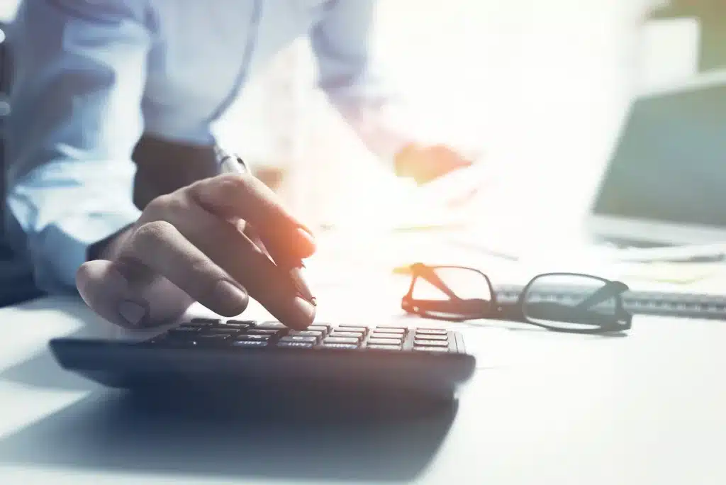 Person using calculator to estimate lost wages in Texas personal injury claim