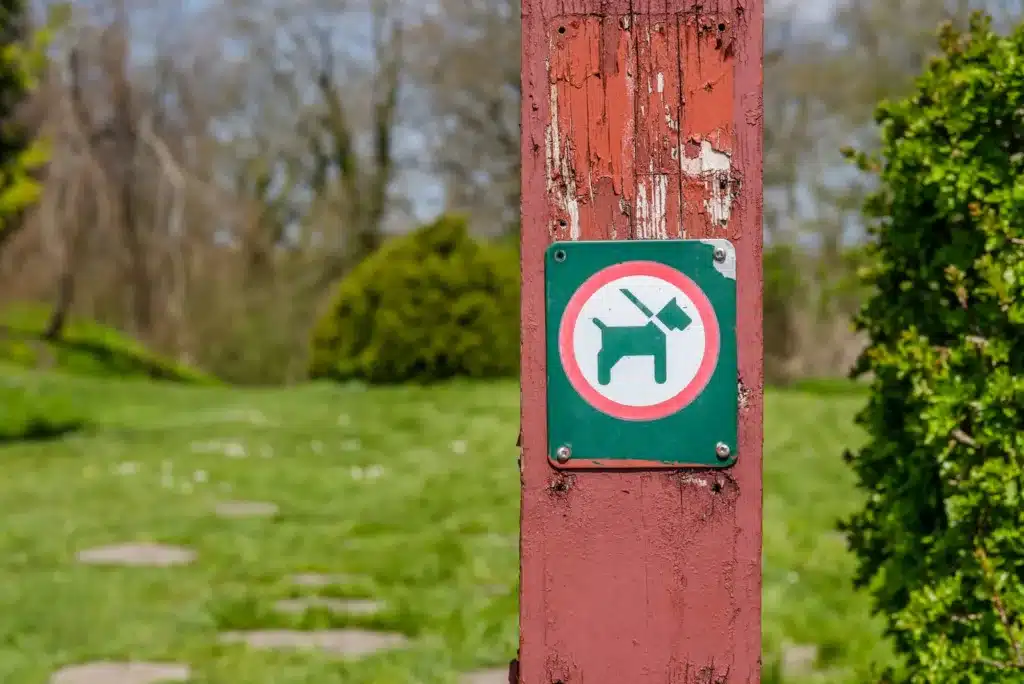 Dog leash required sign on post — Texas leash law