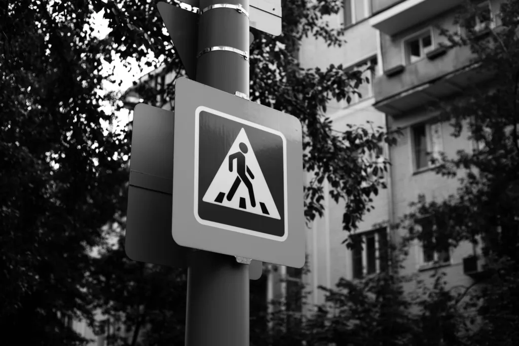 Pedestrian crosswalk sign on a street pole — Florida right of way laws